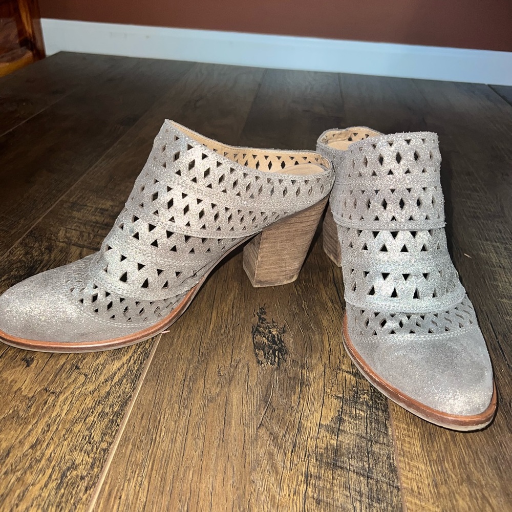 Shiny Silver Heeled Slip on Booties with Aztec cutouts. Super Comfy Steve Madden